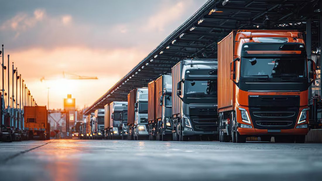Line of trucks at a freight terminal at sunset