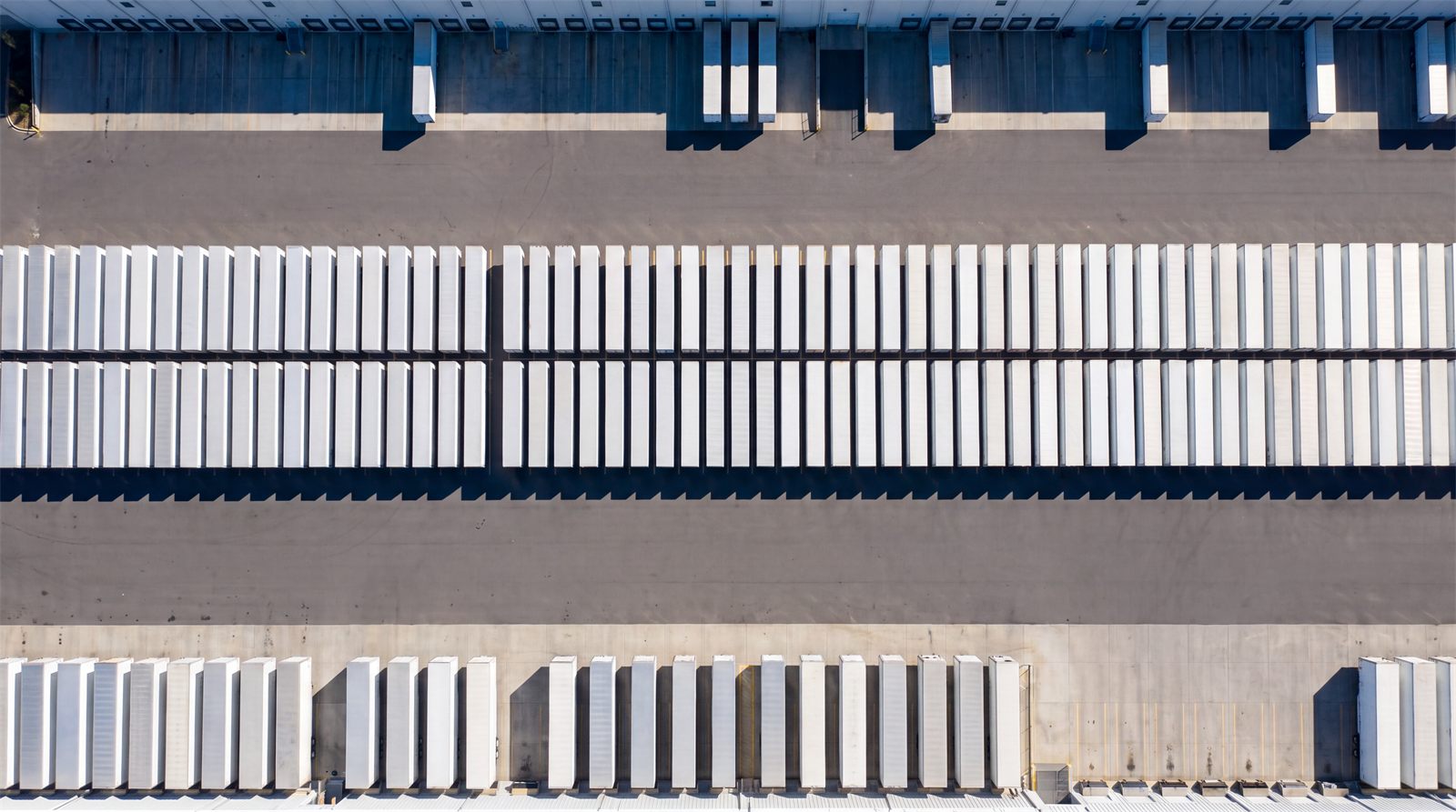 Aerial view of a dedicated trailer pool staged in rows at a distribution center